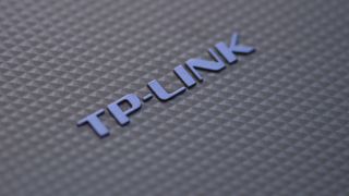 Close-up picture of TP-Link branding on a router device.