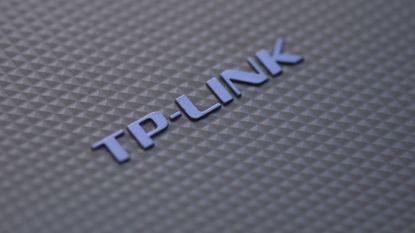 Close-up picture of TP-Link branding on a router device.