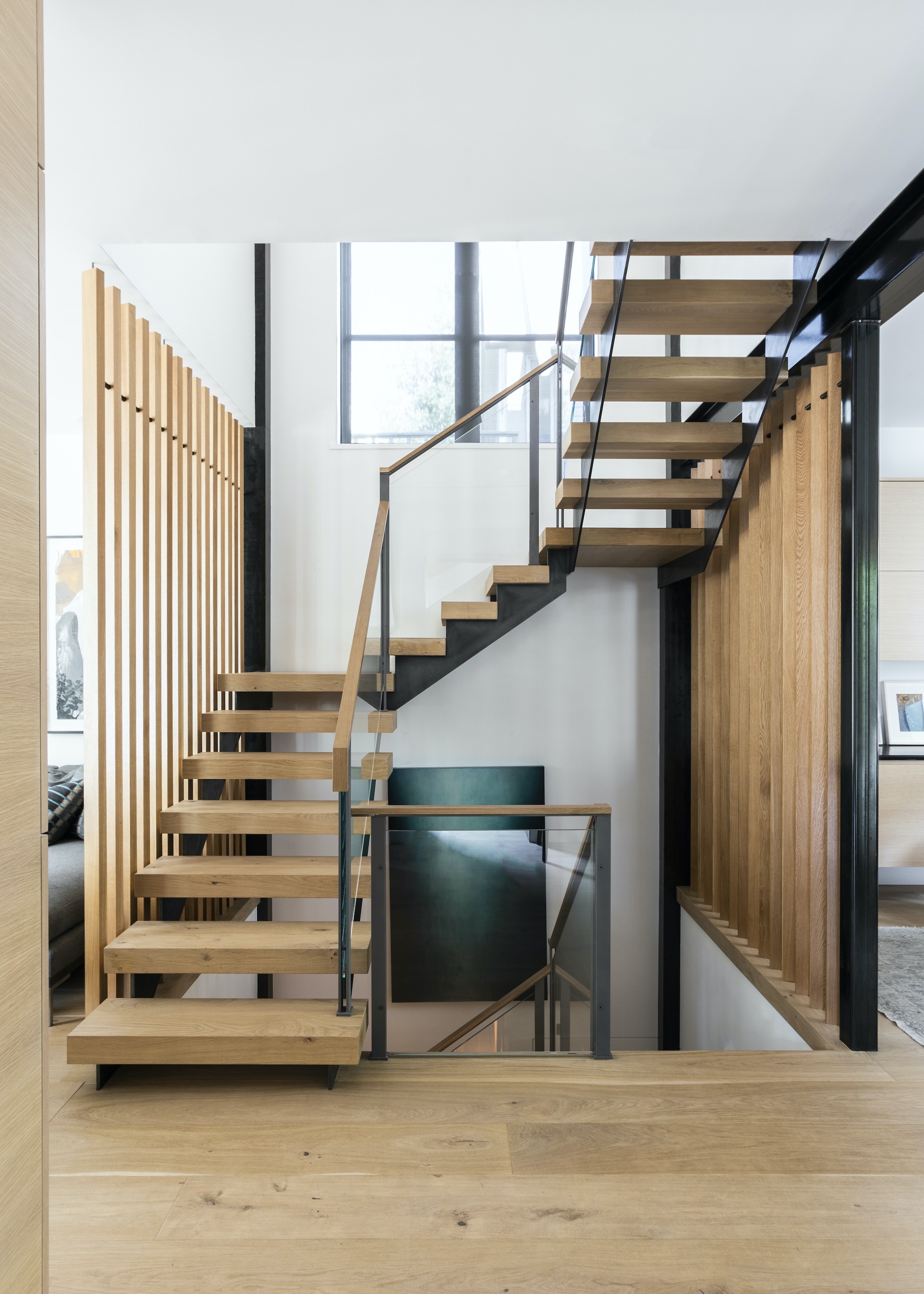 open staircase with chunky wooden steps and black metal stringers