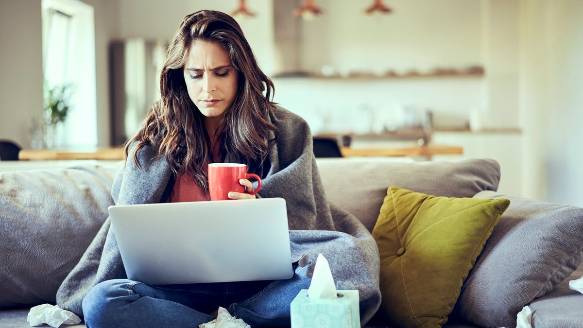 a photo of a woman on the sofa with a headcold 