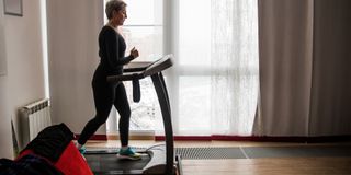 Image of woman using treadmill at home