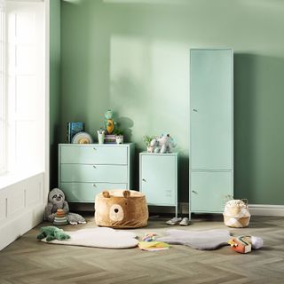 Kids bedroom with green chest of drawers and wardrobe