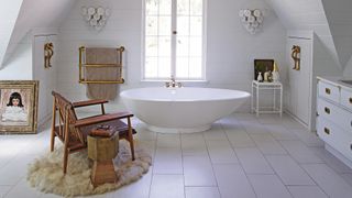 White bathroom with sleek freestanding bath tub