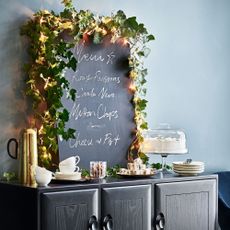 Navy room with chalk board and black console