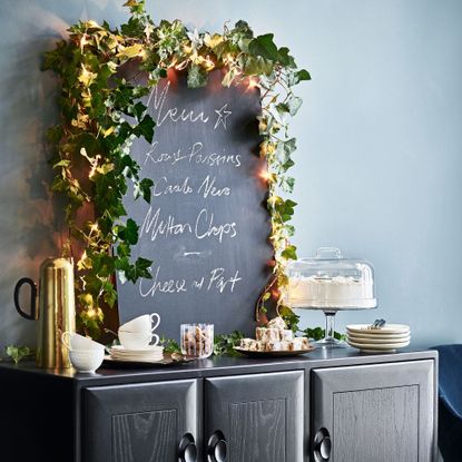 Navy room with chalk board and black console