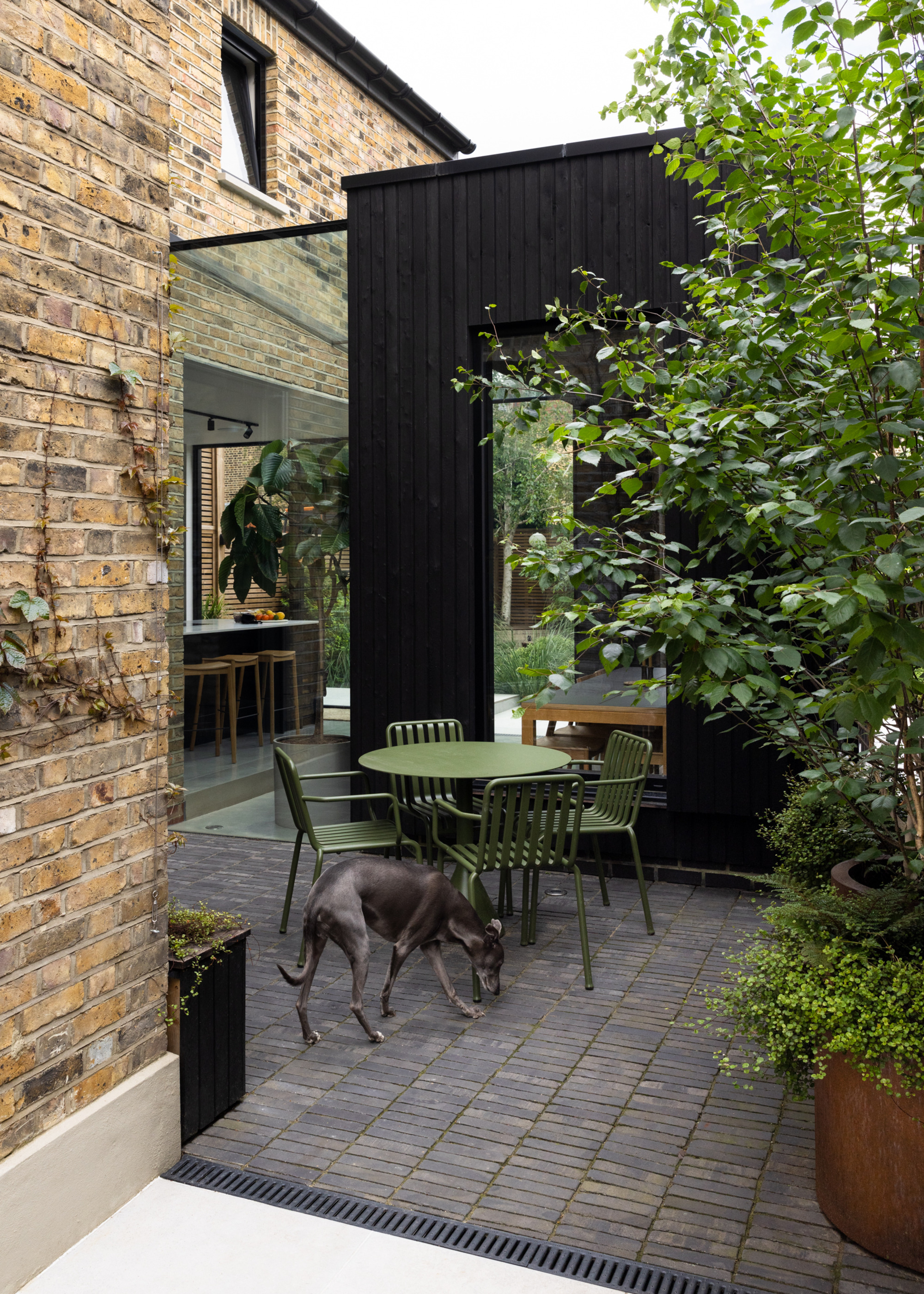 green table and chairs on patio with discreet drainage channel