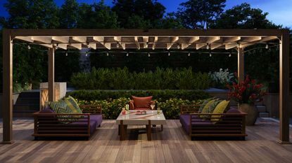 Modern Decking With Sofa, Armchair, Coffee Table And Garden View Background At Night - for article on decking privacy mistakes