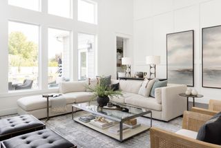 A neutral living room with large wall art