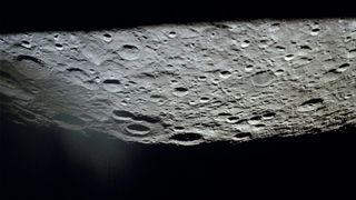 The farside of the moon, photographed by Apollo 13, hangs upside-down over the blackness of space