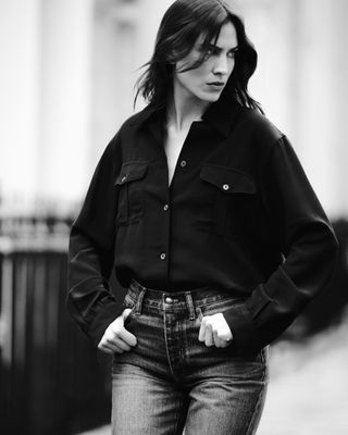 alexa chung wearing a button up shirt and jeans