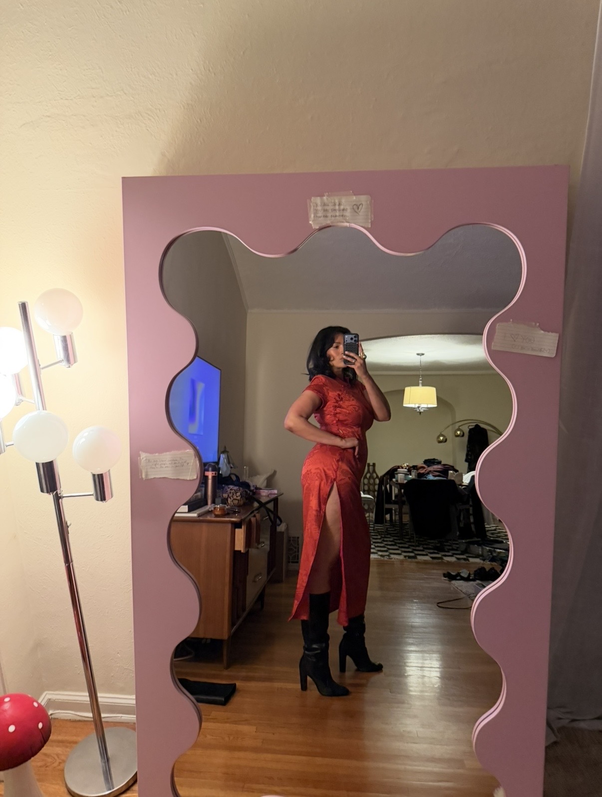 jennifer atilemile wearing black boots and a red dress