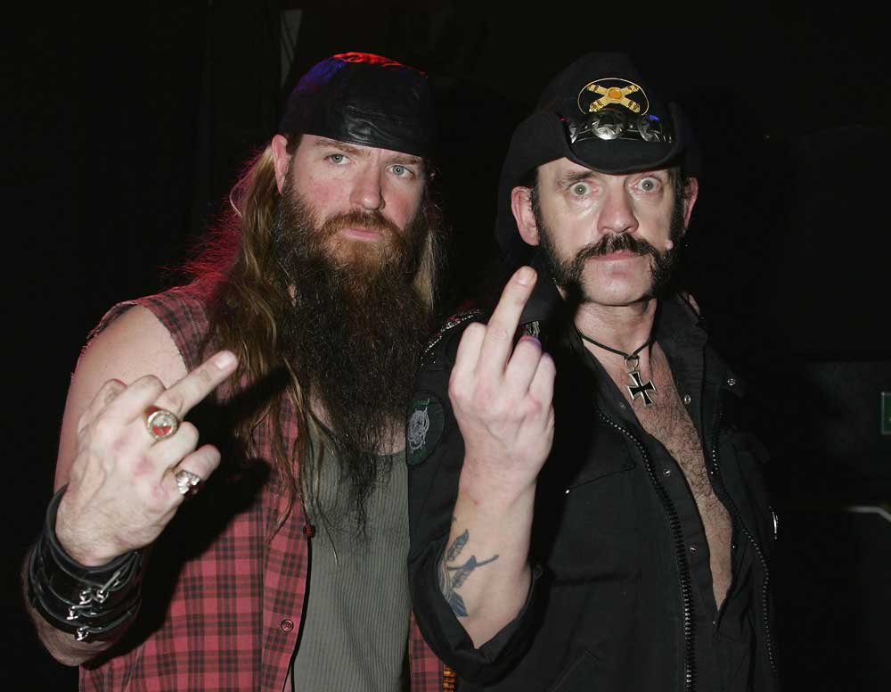 Zakk Wylde and Lemmy extending middle fingers towards the camera