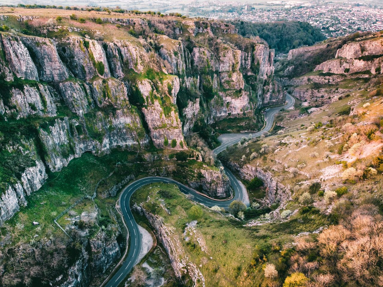 Aerial drone photo of Cheddar Gorge, Somerset UK. Taken at sunrise to capture the warmth of the light coming through the gorge and light on the rocks