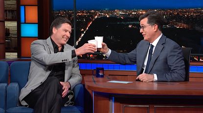 Stephen Colbert shares a cup of wine with James Comey