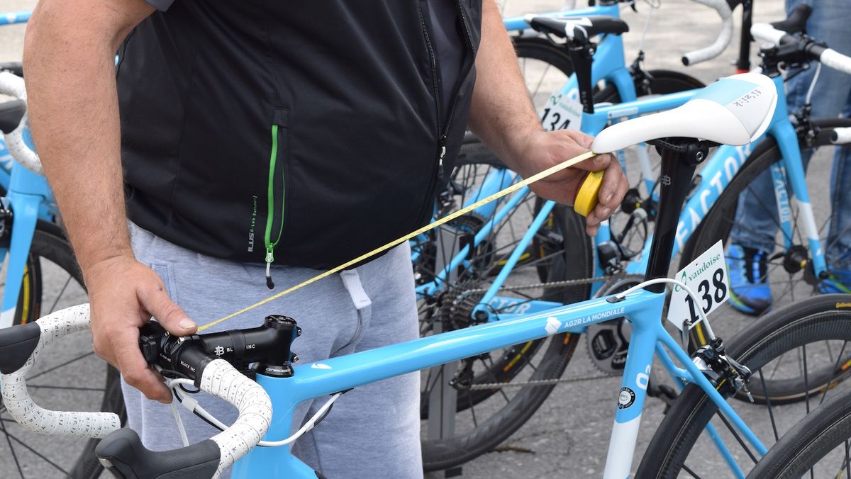 An AG2R La Mondiale mechanic checks the bike setups ahead of the race start