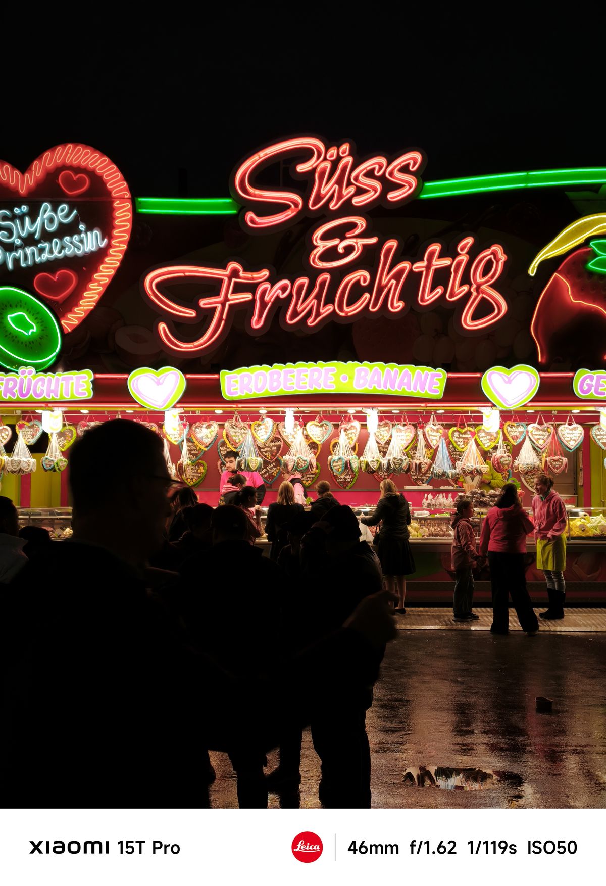 A carnival stand lit up at night