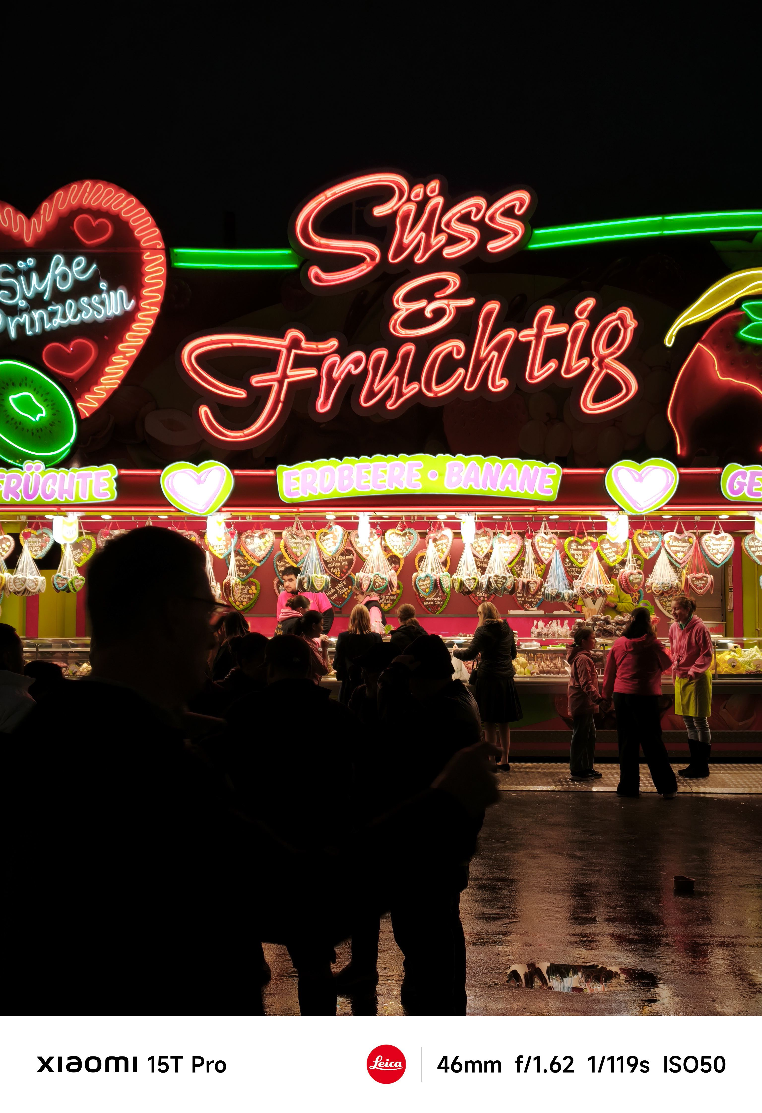 A carnival stand lit up at night