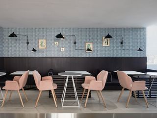 Eating area with pink tables and white chairs
