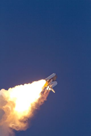 Space shuttle Discovery heads to space after lifting off from Launch Pad 39A at NASA's Kennedy Space Center in Florida to begin its final flight to the International Space Station on the STS-133 mission.
