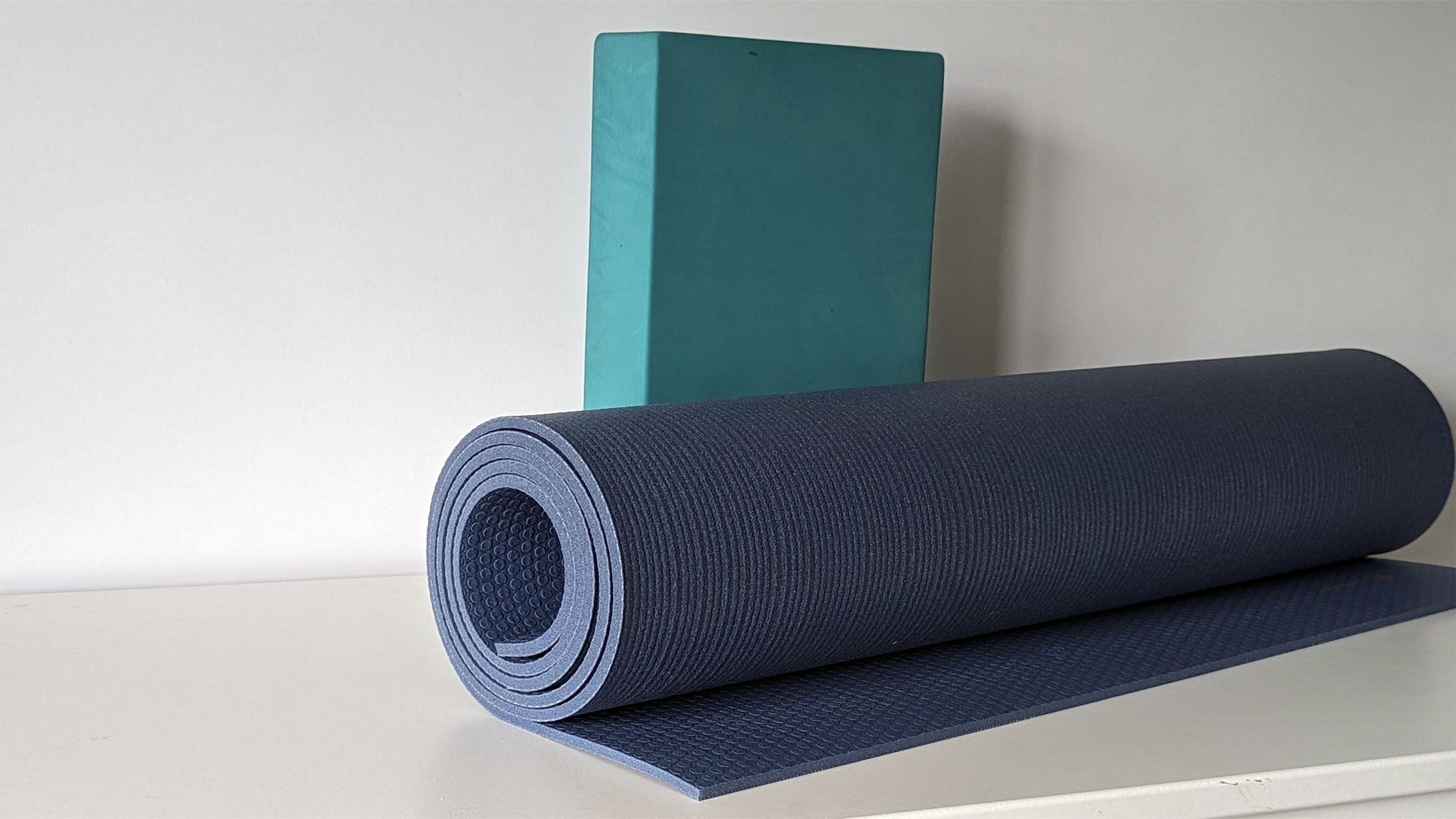 Manduka PRO yoga mat being propped up with a yoga block