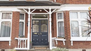 blue double front door with white wooden porch on edwardian house