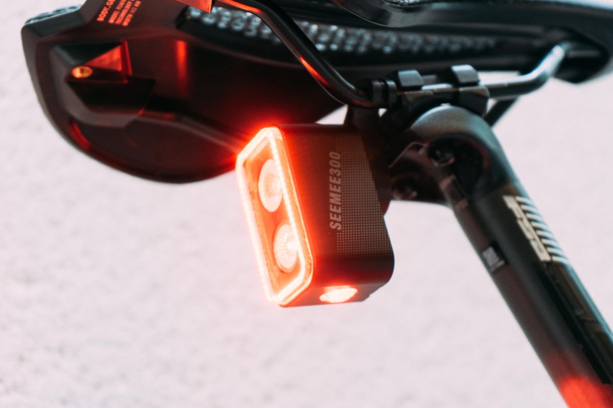 A close up of the Magicshine Seemee300 rear bike light with two bulbs and one bulb underneath