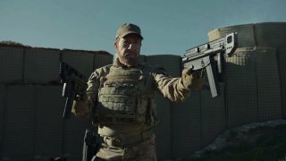 A still from the Agent Recon movie of a character dressed as a soldier and holding a gun.