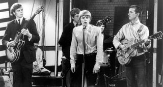 A black and white archive shot of the Yardbirds playing on the TV show Ready Steady Go!, with Clapton on the right with a Gretsch semi-hollow