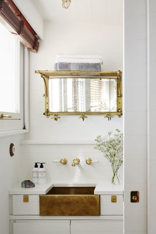 White beachy bathroom with gold mirror