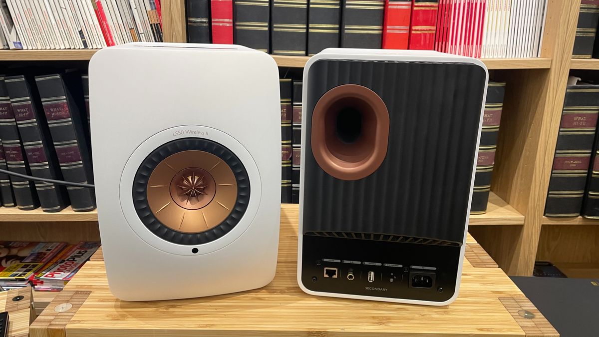 KEF LS50 Wireless II speakers in white finish on a wooden rack