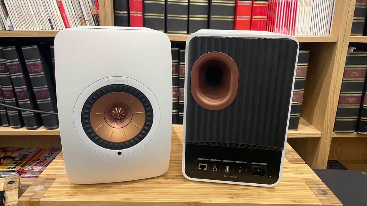 KEF LS50 Wireless II speakers in white finish on a wooden rack