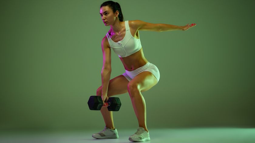 a woman lifting a dumbbell