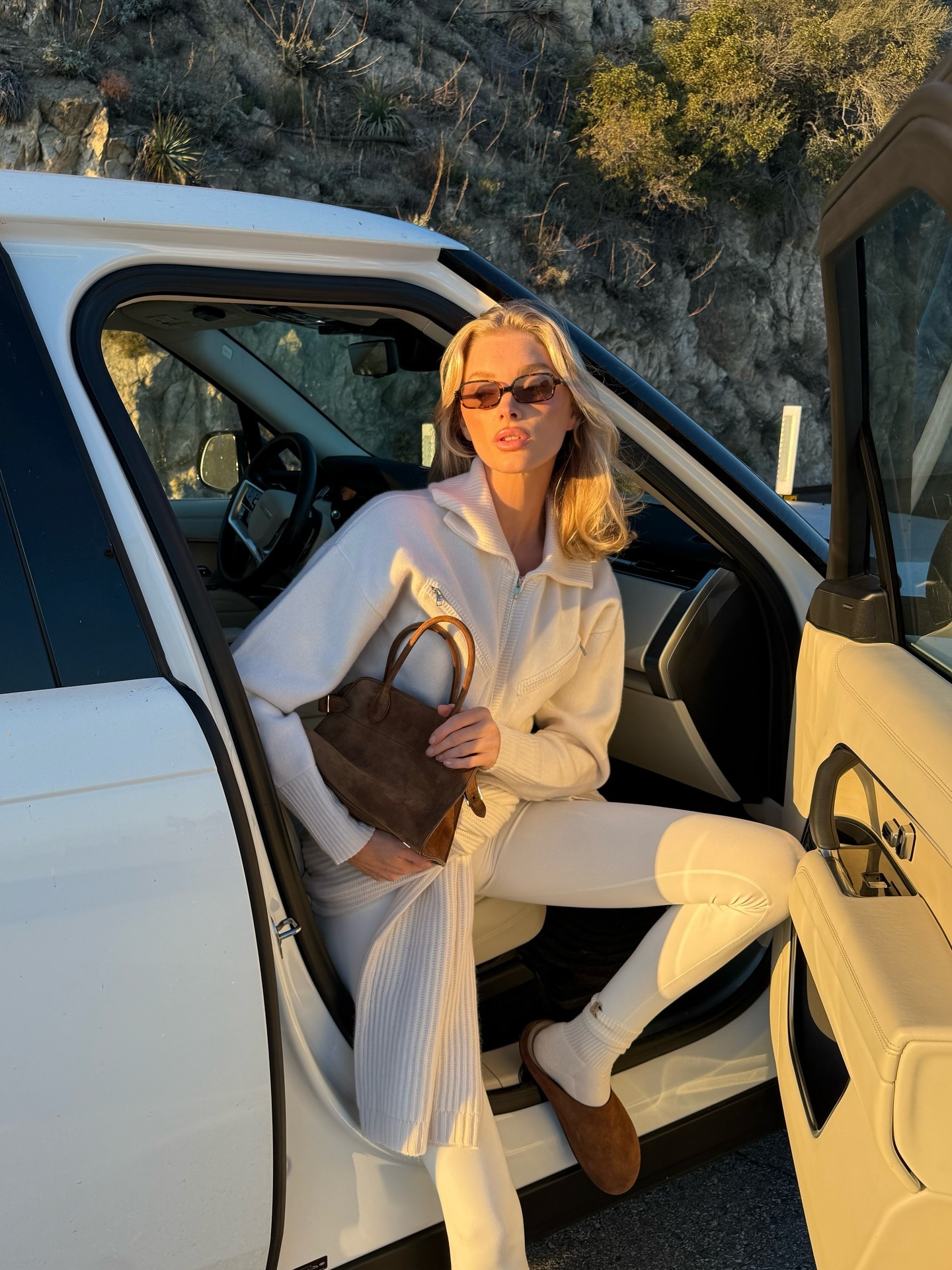 Woman in a white outfit with slip on mules.
