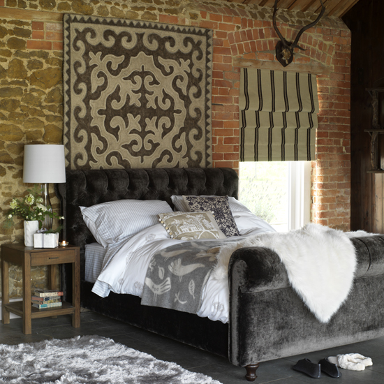 bedroom with velvet bed and lamp