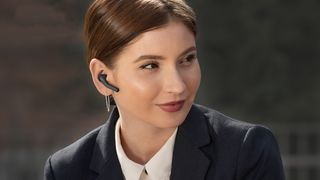 Woman weating Jabra Talk 55 Bluetooth headset.