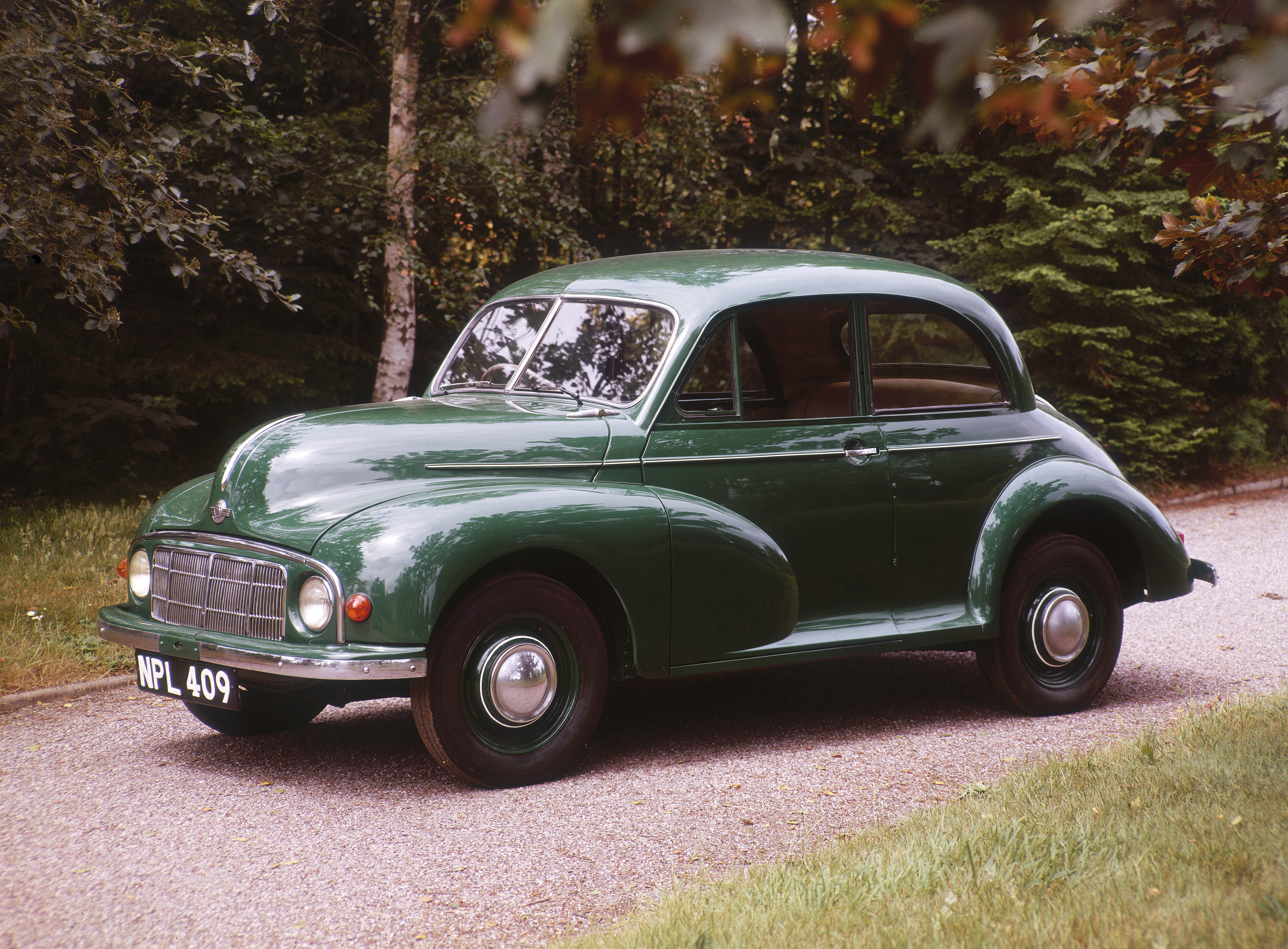 small, dark green, vintage car 