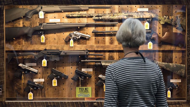 A woman shopping for guns