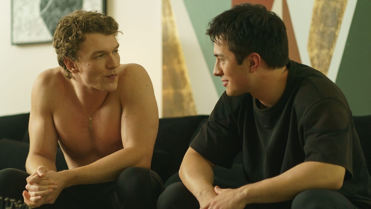 From left to right: Ilya sitting and leaning on his knees while looking at Shane who is looking at him. 