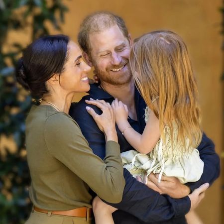 Prince Harry and Meghan Markle holding Princess Lilibet