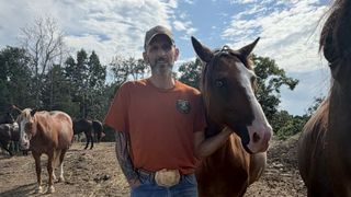 Adam Watson standing with a horse