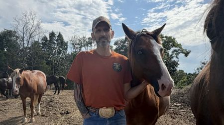 Adam Watson standing with a horse