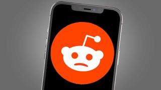 A phone screen showing a sad version of the Reddit logo