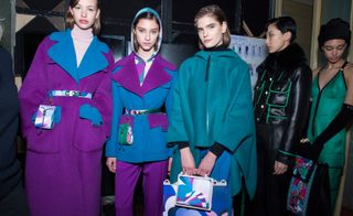 Models wear colourful oversized coats, in purple and blue