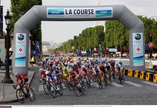 The peloton passes under the La Course sign