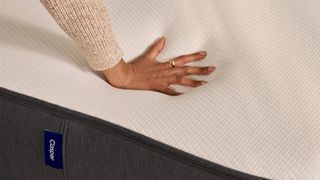 Hand pushing on Casper mattress