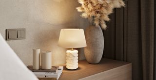 neutral bedroom with a stone lamp on the bedside