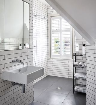loft bathroom with white tiles and walk in shower