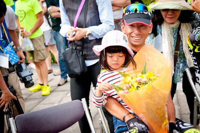 Shinichi Fukushima (Team NIPPO- De Rosa) who is a veteran rider aged 42-years-old, smiling with his daughter after the award ceremony
