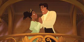 Tiana embraces Prince Naveen while standing on an ornate balcony in 'The Princess and the Frog'
