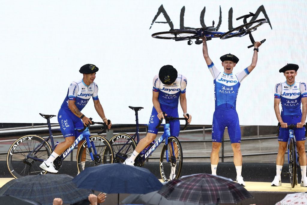 Team Jayco Alulas US rider Lawson Craddock 2nd R raises his bicycle as he and his teammates take to the stage during the official teams presentation near the Guggenheim Museum Bilbao in Bilbao northern Spain on June 29 2023 two days prior to the start of the 110th edition of the Tour de France cycling race Photo by AnneChristine POUJOULAT AFP Photo by ANNECHRISTINE POUJOULATAFP via Getty Images